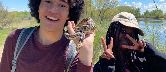AXL 8th grade student holding a bullsnake he found on the overnight trip